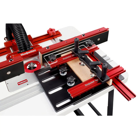 Router Table Coping Sled For Precise Woodworking With Adjustable Top Plate And Fence Guide Five And A Half Inches Capacity Dual Clamps Centered To Prevent Lifting Clear Guide Tracks Along Fence Not Miter Slot Made In USA on a table with red and black components.