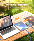 MacBook, iPad, and iPhone charging on picnic table with Solar Powered Camping Fan With Led Lantern 7W Panel 10400mAh