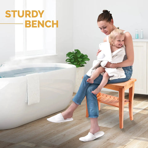 Woman sitting on Dope Bamboo Shower Bench Spa Stool With 2 Tier Wood Seat next to bathtub, holding child in bathroom.