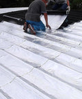 Two workers applying Heavy Duty Aluminum Foil Roofing Tape Self Adhesive Asphalt Shingle Repair Seal on a roof surface.