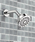 Ignite Chrome Five Function Shower Head With 2.5 GPM High Pressure Spray and customizable modes on tiled wall