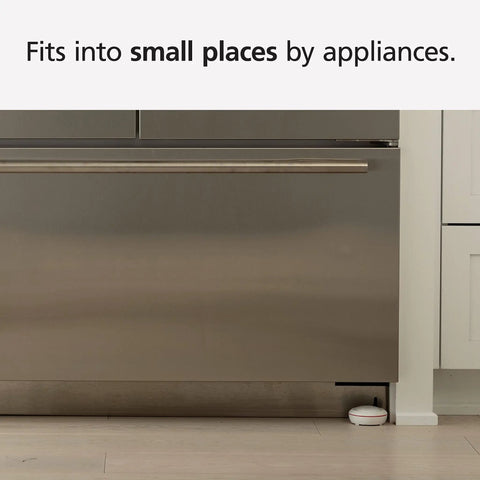 WiFi Water Leak Detector and Freeze Alarm with Alexa Compatibility placed near kitchen appliance