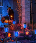 8 Pack Blue Solar Torch Lights With Lit Flickering Flame for outdoor decor with Halloween pumpkins on porch at night