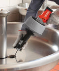 Professional Grade Pneumatic Air Powered 230V Drain Cleaning Tool in use over a sink, demonstrating heavy-duty clog removal.