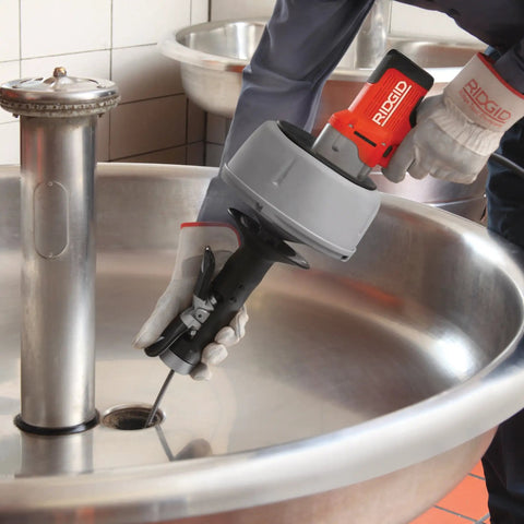 Professional Grade Pneumatic Air Powered 230V Drain Cleaning Tool in use over a sink, demonstrating heavy-duty clog removal.