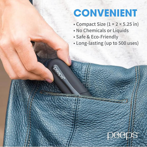 Peeps eyeglass lens cleaner in dark gray, compact size tucked into blue jeans pocket; Peeps logo visible.