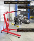 2 Ton Cherry Picker Engine Hoist Folds Flat To Save Bay Space Rolls Smooth On Six Heavy Duty Casters Includes Hand Pump For Garage Crew Auto Projects 4400 Lb, with engine hanging.
