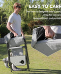Man carrying folded Oversized Directors Camping Chair Set Of 2 Built To Haul 600 Lbs Capacity Heavy Duty Folding Outdoor Chairs with strap