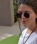 Woman wearing 18 Inch Black Silk Satin Cord Necklace Hypoallergenic Rope Jewelry with sunglasses outdoors