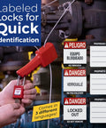 Person using red lockout device with bilingual danger labels for equipment maintenance safety.