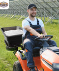 Man operating utility tractor with 12V Grass Seed And Fertilizer Spreader With 80 Pound Capacity Hitch Mount Receiver in field.