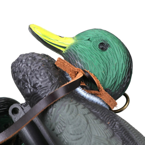 Close-up of leather game carrier strap securing duck decoy, highlighting detail and use for Leather Game Carrier Strap Belt With 12 Drop Slip Rings For Dove Duck Quail Pheasant And Other Small Game Bird Tote Hanger For Field Hunting Gear And More Today.
