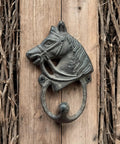 Handcrafted Cast Iron Horsehead Wall Hook With A Knockout Rustic Coffee Bean Brown Finish Built Like A Tank For Hanging Coats Keys Hats And Gear Includes Hardware mounted on wood background.