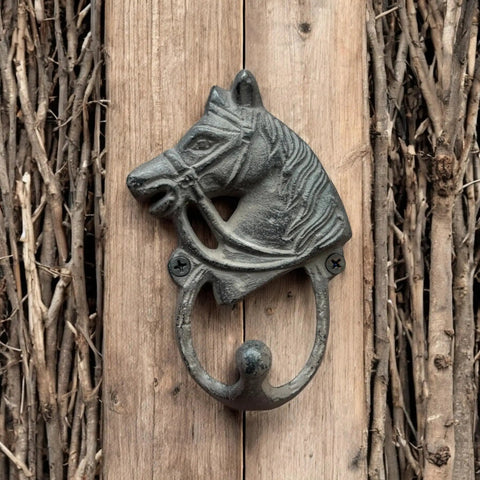 Handcrafted Cast Iron Horsehead Wall Hook With A Knockout Rustic Coffee Bean Brown Finish Built Like A Tank For Hanging Coats Keys Hats And Gear Includes Hardware mounted on wood background.