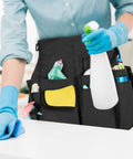 Pro Grade Cleaning Apron With 9 Pockets And Adjustable Waist Belt For House And Hotel Jobs Durable Black Caddy Apron With Comfortable Fit And Flexible Strap Great For Pros And Daily Cleaning worn by person cleaning surface