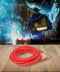 25 Foot SuperFlex TIG Torch Power Cable for CK9 CK17 Series Welders, red, coiled on wooden surface next to welding scene