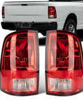 Tail Lights for Dodge Ram 1500 2500 3500 2009 2010 2011 2012 2013 2014 2015 2016 2017 2018 Left Driver and Right Passenger Rear Brake Back Up Lens Assembly with Lamps Included Direct Fit Plug and Play displayed in front of truck.
