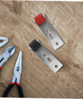 Heavy Duty Silent Sliding Door Wheels For Barn Gates Smooth As Butter Roller Guides on wooden surface with pliers and tools.