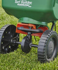 Edge Guard Mini Broadcast Spreader With Calibrated Settings And Wheels on grass, ideal for lawns up to 5,000 sq ft.