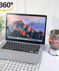 Mudder Silver Rotating Display Turntable Base For Epoxy Tumbler, 360 Degree Electric Spinner With USB Power Cord beside a laptop.