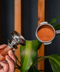 Killer 54Mm Bottomless Portafilter Set For Breville Espresso Machines showing calibrated tamper and portafilter with coffee grounds.