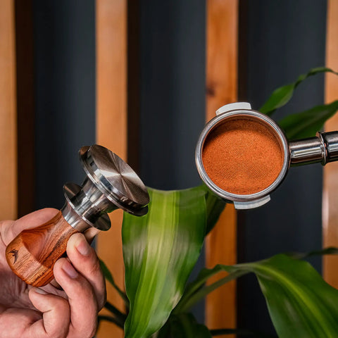 Killer 54Mm Bottomless Portafilter Set For Breville Espresso Machines showing calibrated tamper and portafilter with coffee grounds.