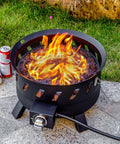 Smokeless Portable Propane Fire Pit For Outdoor Use With Lid And Handle Seventeen Point Three Inch Gas Fire Bowl lit in yard