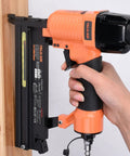 Hand holding the Straight Shooter 18 Gauge Pneumatic Brad Nailer And Twofer Air Stapler, showing aluminum design for carpentry.