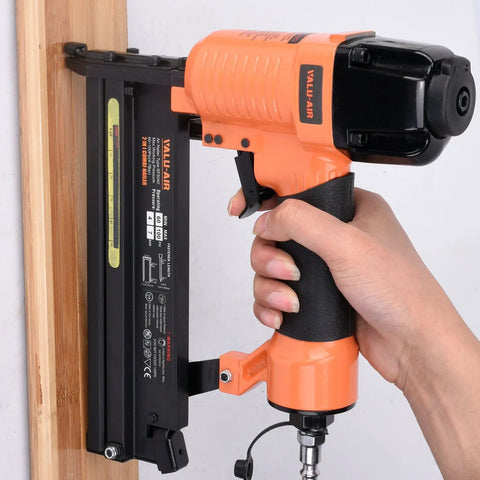 Hand holding the Straight Shooter 18 Gauge Pneumatic Brad Nailer And Twofer Air Stapler, showing aluminum design for carpentry.