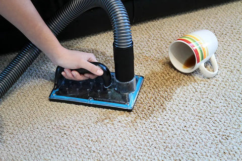 Person using Sub Surface Extraction Tool 71 001 For Carpet Cleaning Odor Elimination And Deep Stain Removal, near spilled coffee cup