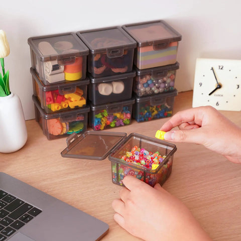 Person organizing beads into 10 Pack Small Plastic Storage Containers With Lids Black Square Mini Boxes For Beads Crafts Jewelry Findings Stickers Tiny Tools And Small Items Stackable Organizer Bins on a desk.