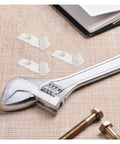 Clear Plastic Shelf Supports Locking Pins Set Of 60 For Cabinets And Shelves displayed with tools and a notepad