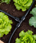 Thirty Piece Quick Connect Drip Irrigation Tee Fittings Kit For One Quarter Inch Tubing in garden setup with lettuce