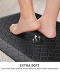 Foot resting on black Ergonomic Anti Fatigue Kitchen Floor Mat 4 To 5 Inch Thick Waterproof Non Slip Rug for standing comfort.