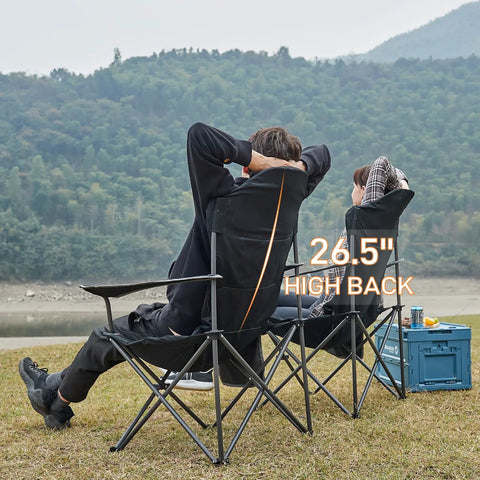 People relaxing by a lake on oversized folding camping chair with high back padded comfort, 2 pack portable lawn chairs, black.