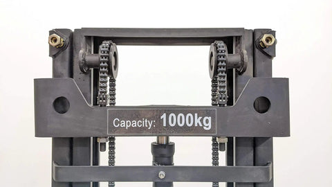 Heavy Duty Electric Thin Leg Pallet Stacker As A No Fuss Heavy Hitter With 2204 Lb Load Capacity and 130 Inch Lift Height showing 1000kg capacity sign and chain drive.