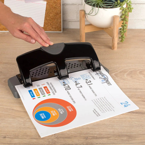 No Sweat Heavy Duty Three Hole Puncher With 20 Sheet Capacity Solid Steel Frame, black color with paper and hand adjusting.