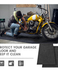 Mechanic working on a motorcycle on a Four Piece Oil Spill Mat Set 36 By 60 Inches For Garage Floor Protection Reusable Washable Oil Drip Mats