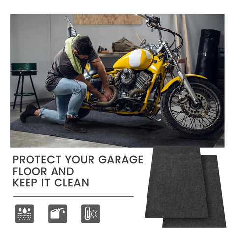 Mechanic working on a motorcycle on a Four Piece Oil Spill Mat Set 36 By 60 Inches For Garage Floor Protection Reusable Washable Oil Drip Mats