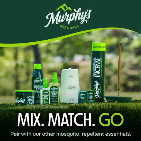 Display of Murphy's Naturals mosquito repellent products including sprays, incense, and candles outdoors.