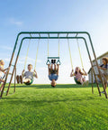 Kids playing on Backyard Swing Set Built Tough With Monkey Bars Trapeze Bar And Two Belt Swings Heavy Duty Metal Playground In Green And Brown