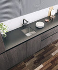Overhead view of undermount 23x18x9 single bowl kitchen sink in 18 gauge 304 stainless steel with black finish, installed in a modern kitchen counter.