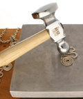 Two-Sided Chasing Hammer With Wooden Handle And Steel Head, 14mm Ball Pein And 28mm Domed Face, used on metal coiling on block