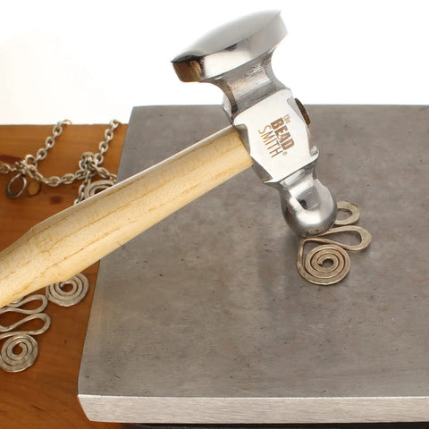 Two-Sided Chasing Hammer With Wooden Handle And Steel Head, 14mm Ball Pein And 28mm Domed Face, used on metal coiling on block