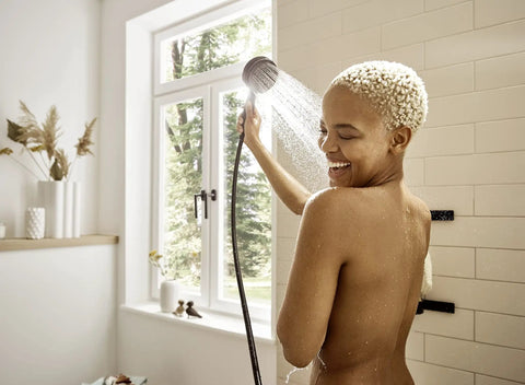 Person using Pulsify S Handheld Shower Head Set Matte Black Finish With Three Spray Modes Including PowderRain QuickClean Technology