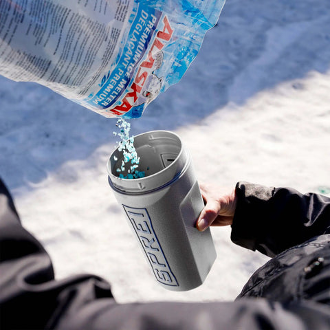 Person using Spot Spreader 80 Oz Handheld Grab-And-Go Dispenser for salt, showing open lid and strong handle in snowy environment.