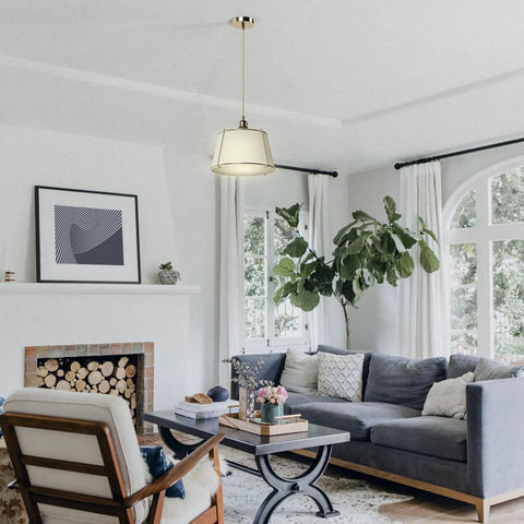 Cozy Linen Shade Pendant Light With Cream White Shade In Gold Cage, Adjustable Cord And Canopy, ETL Listed in a living room.
