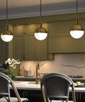 Eight Inch Wide Small Pendant Light With Glass Shade In Brass And White Milk Glass Perfect For Modern Kitchens And Compact Spaces Use In Multiples Over A Kitchen Island For Cohesive Lighting