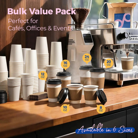 Assorted sizes of disposable coffee cups with lids on a counter near a coffee machine.