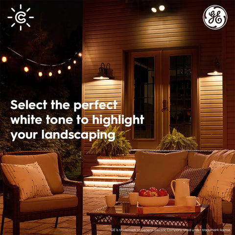 Outdoor patio with Cync Outdoor PAR38 Flood Smart LED Bulbs With WiFi, Color Changing, illuminating seating area and landscape at night.